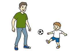 息子とサッカーをする父親